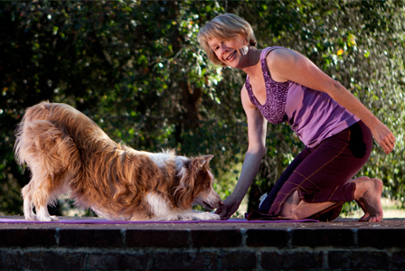 Woman and dog doing yoga