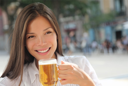 Woman drinking beer outside