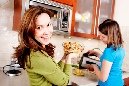 Woman reheating dinner