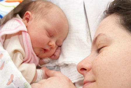 Mother with newborn baby daughter