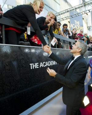 George Clooney signs autographs at the Oscars