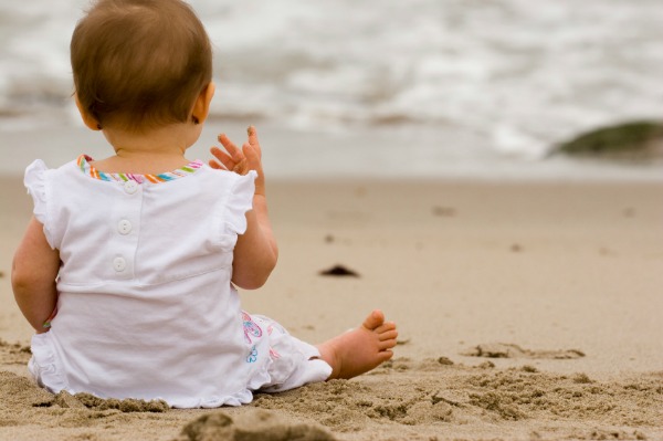 baby sitting on beach