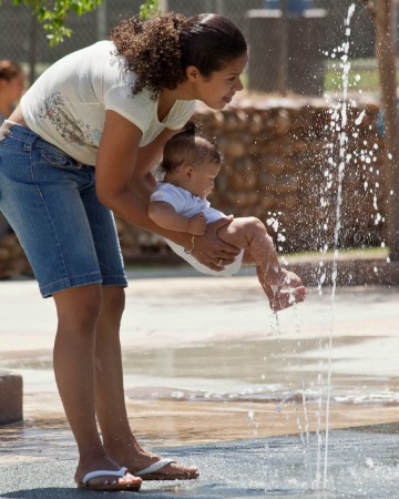 baby and mother at outdoor splash park