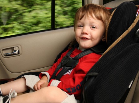 Happy kid in a car seat