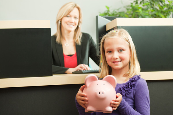Child with piggy bank at bank