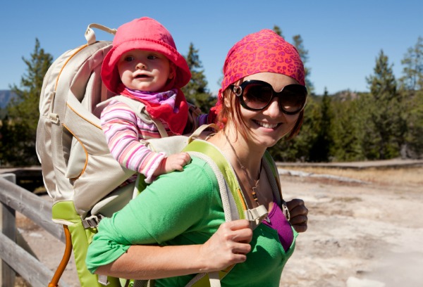 mom hiking with baby in carrier on back