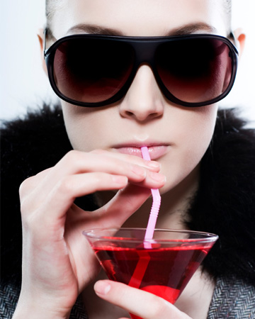 Stylish woman drinking cocktail