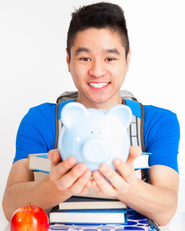 Teen boy with piggy bank