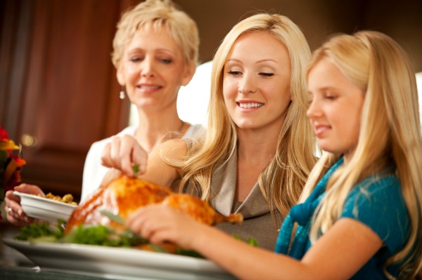 Grandmother, mother and daughter prepping turkey