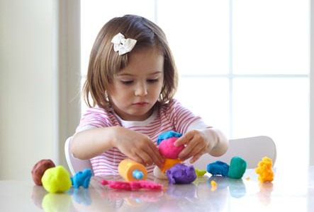 preschooler playing with play dough