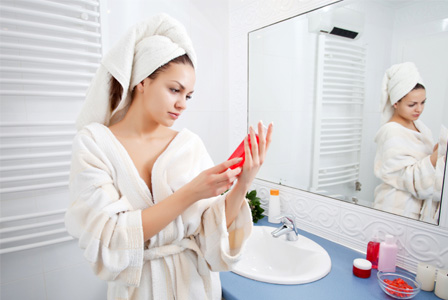 Woman reading lotion label