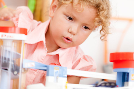 Girl playing with toy cras