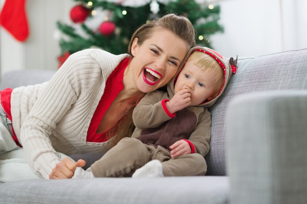 Mother with baby boy eating cookie on Christmas