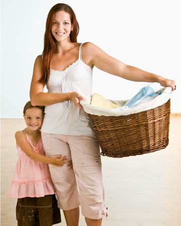 woman holding basket of clean laundry