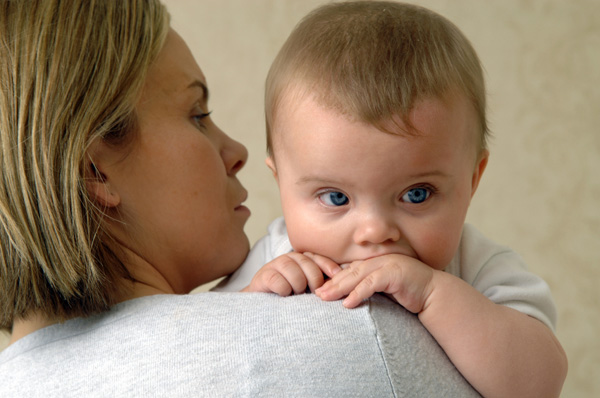 Mother looking into baby's ear