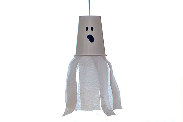 A ghost made out of a white paper cup and white streamers hanging from the bottom.