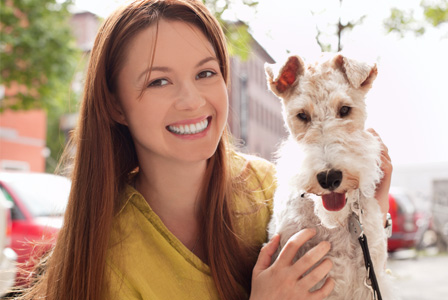 Woman with dog in city