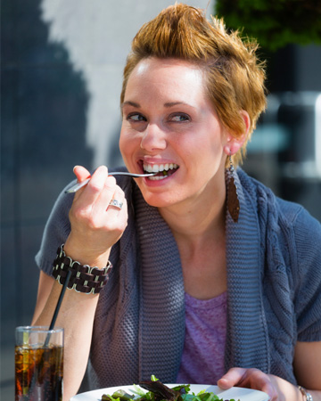 Hip woman eating salad