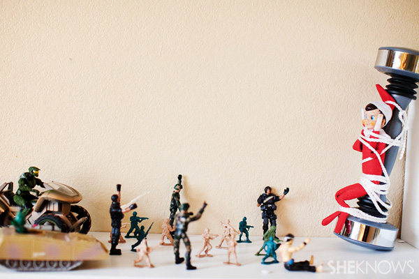 Elf on the Shelf idea 26: Elfie Rojo is captured by Army men