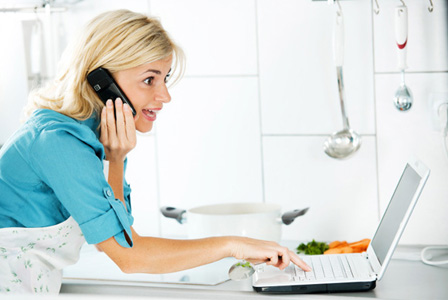 Woman on phone in kitchen