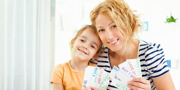 mom and daughter clipping coupons