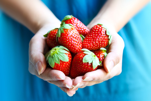 Woman holding fresh strawberries