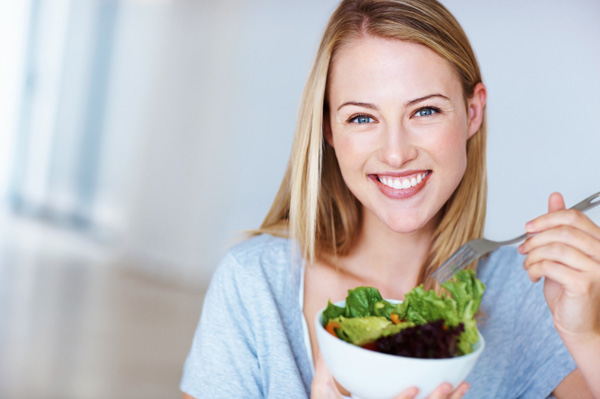 Woman eating salad