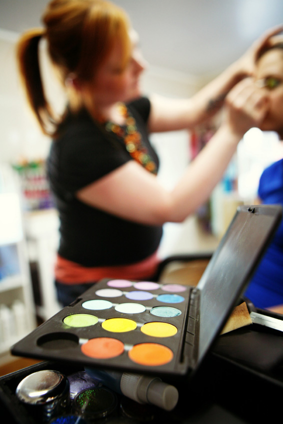 Woman getting makeup done by makeup artist
