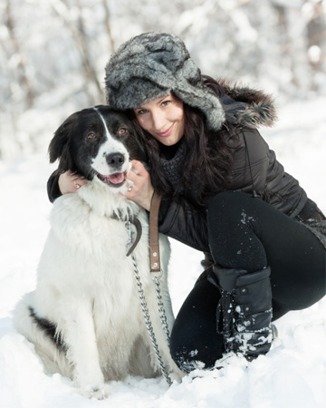 Woman with dog in snow