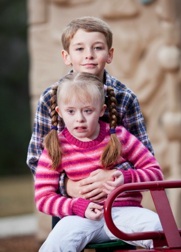 Siblings on playground - Girl with Down syndrome