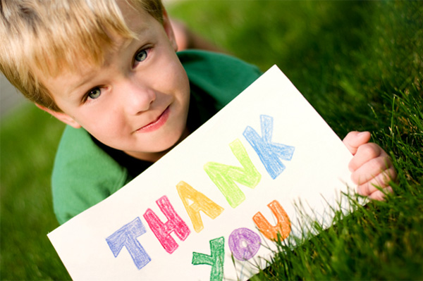 Boy holding up a thank you sign