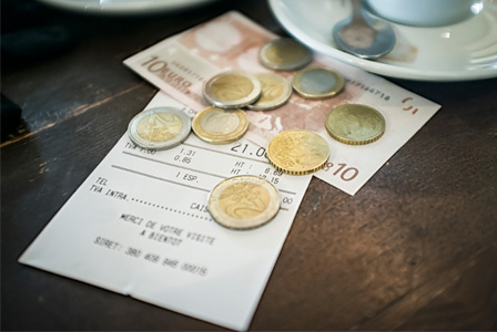 Cafe bill being paid for with Euros