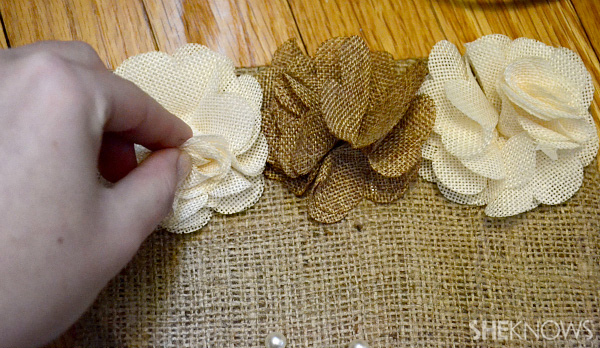 Glue decorative accessories to the burlap