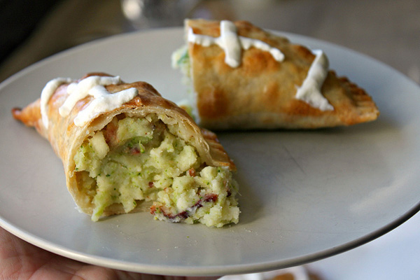 Football empanadas stuffed with mashed potatoes, broccoli, crispy bacon and cheese