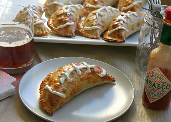 Football empanadas stuffed with mashed potatoes, broccoli, crispy bacon and cheese