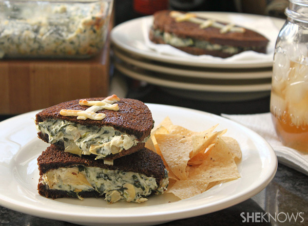 Football shaped grilled cheese sandwiches stuffed with spinach artichoke dip