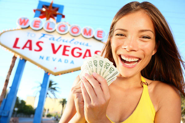 Happy woman in front of Las Vegas sign