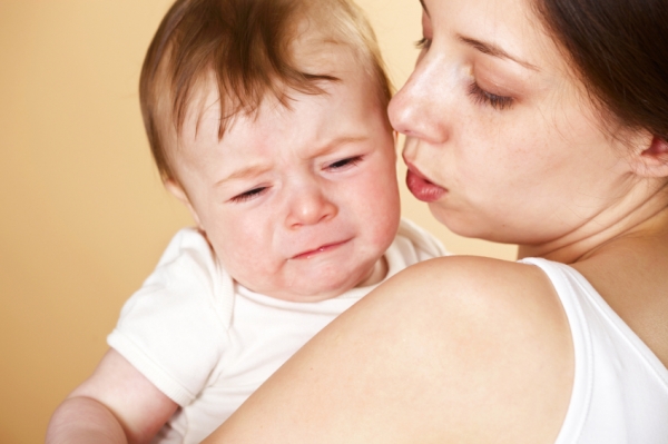 mom comforting sick baby