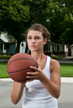 Teen playing basketball