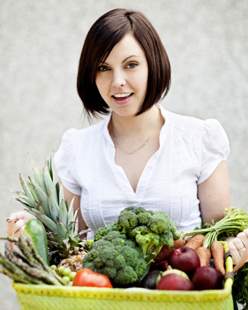 Woman holding basket of vegetables