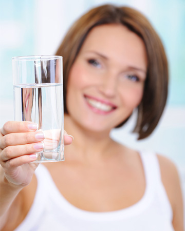 Woman holding glass of water