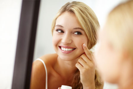 Girl applying face cream
