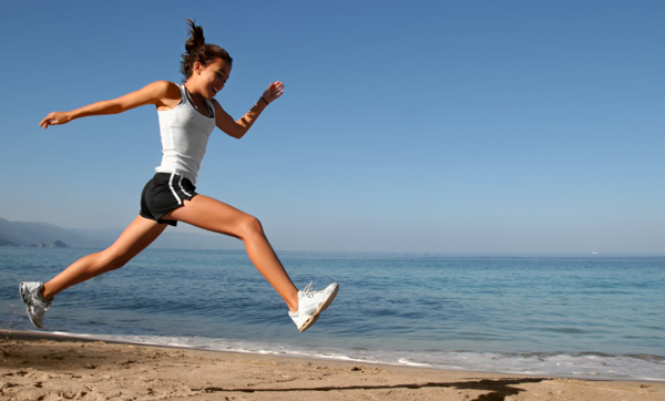 Woman running on San Diego beach