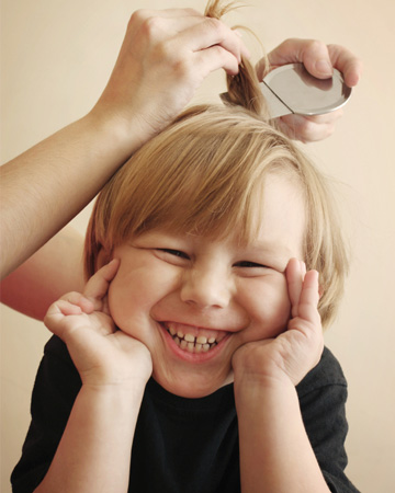 Little boy having lice treatment