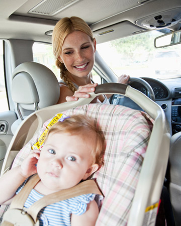 mom driving baby in car seat