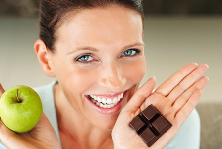 Woman with apple and chocolate