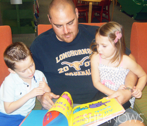 Dad reading to kids