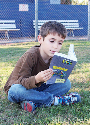 Simon reading outdoors