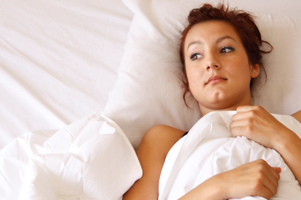 unhappy woman in bed