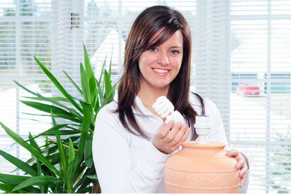Woman installing an eco friendly light bulb